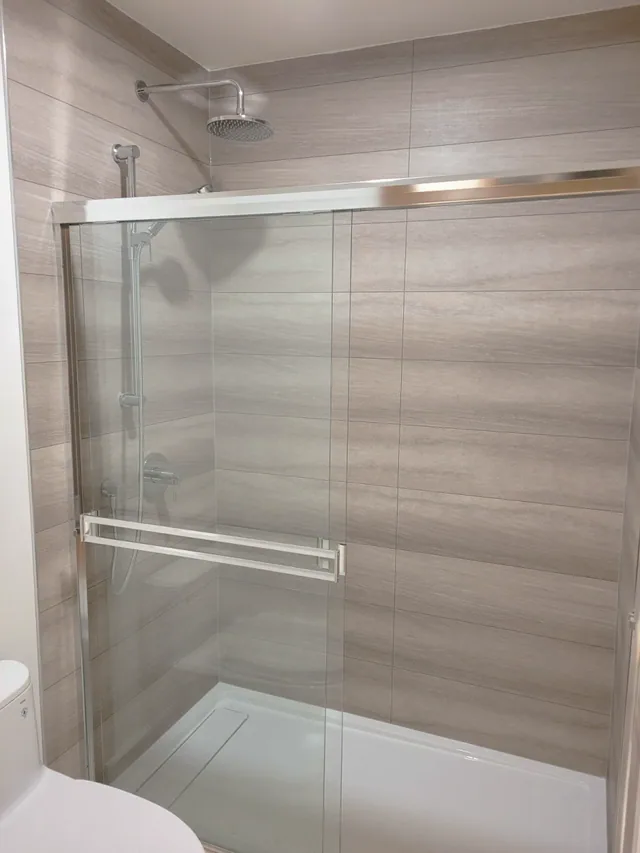 Shower with sliding glass doors and wood-look tile-less panels, Calgary