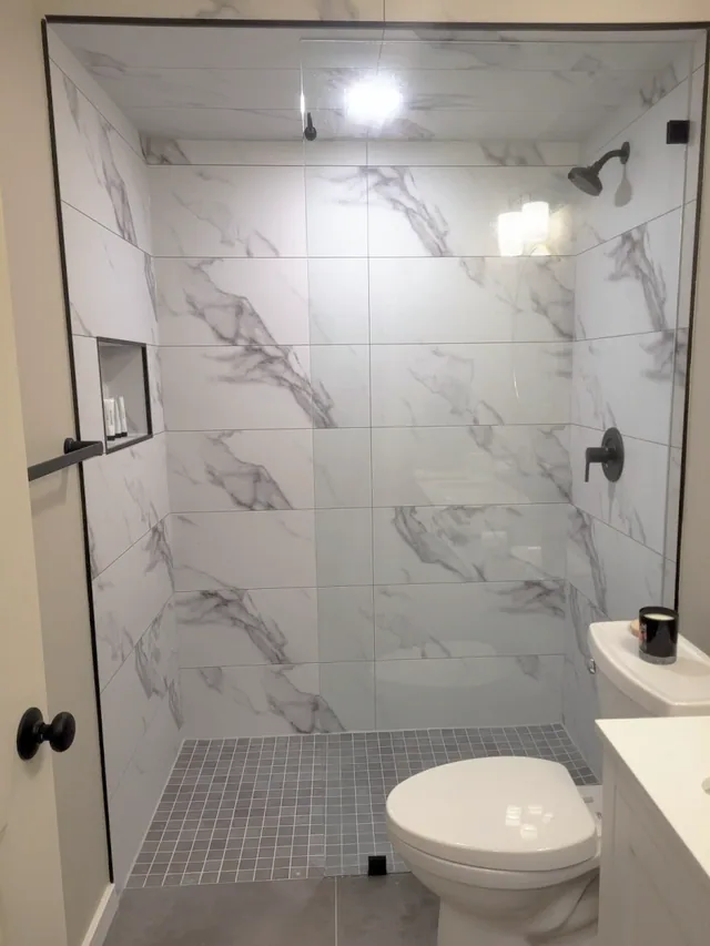 Tile-less shower wall panels in a white marble finish, Calgary